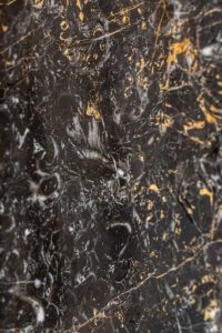 golden black with black background. gold and white color pattern veins in stone