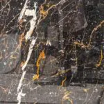 golden black marble stone slab closeup