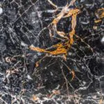 golden black marble stone slab closeup