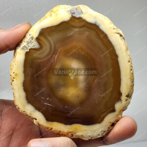Brazilian cream brown agate stone in hand