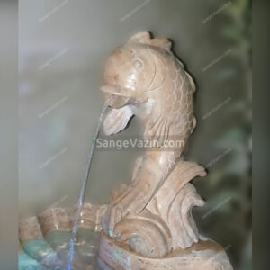 Fish and wave stone fountain`s water flow