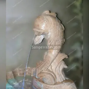 Fish and wave stone fountain`s water flow