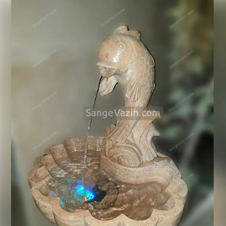 Fish and wave stone fountain`s water flow