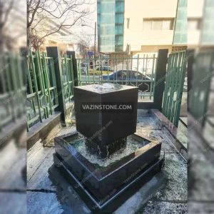 Suspended cubic stone fountain