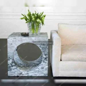 Cube stone coffee table next to the furniture