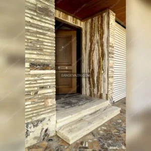 Building entrance with the design of a four-matched slab in the wall