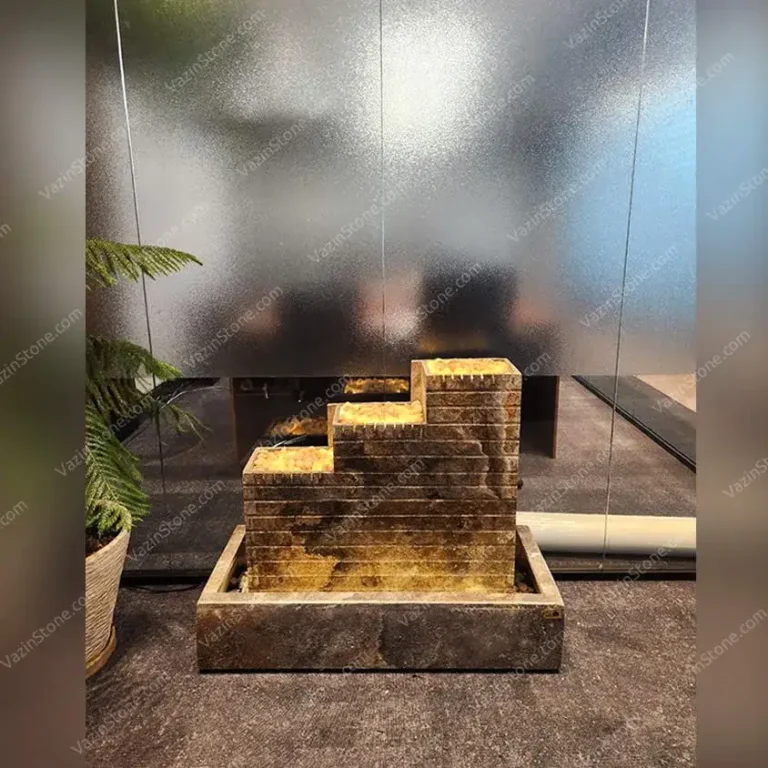 Three tak stone fountain in a lobby