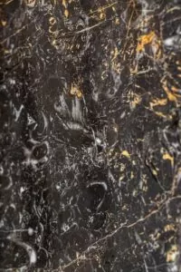 golden black with black background. gold and white color pattern veins in stone