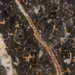 golden black marble stone slab close up
